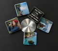 Set of square coasters with scenic and motivational designs on a dark surface