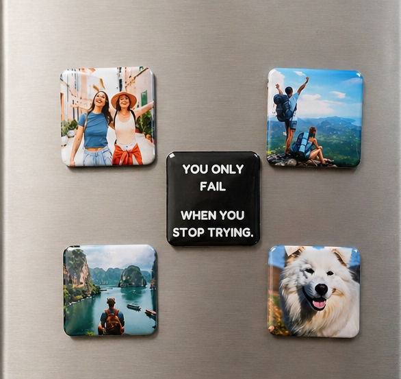 Fridge magnets with various images and a motivational quote on a metallic surface