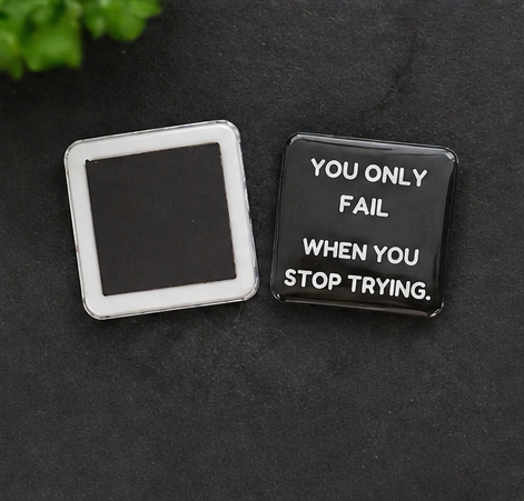 Motivational quote badge on a dark surface