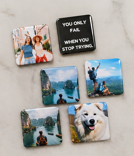 Set of coasters with scenic and motivational designs on a marble surface